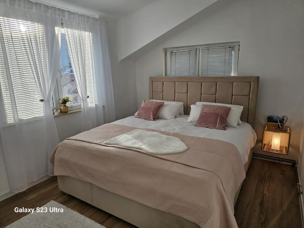 een slaapkamer met een groot bed en een deken bij Apartment City View in Bihać
