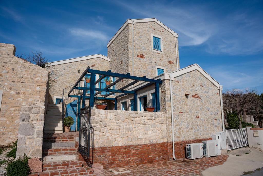 a brick building with a window on the side of it at BEACH HOUSE CASKA in Novalja