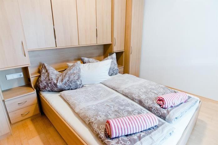 a bed with pillows on it in a room at Appartement Comfort in Gröbming