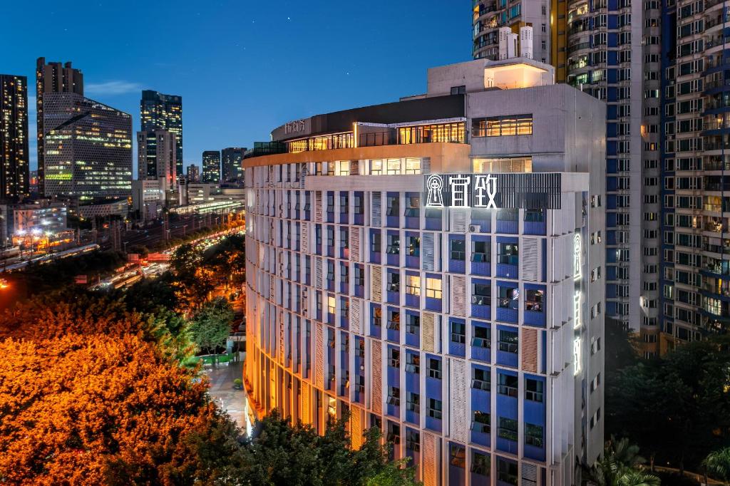 a view of a building in a city at night at Yizhi Hotel - Guangzhou East Railway Station Tianhe Sports Center in Guangzhou