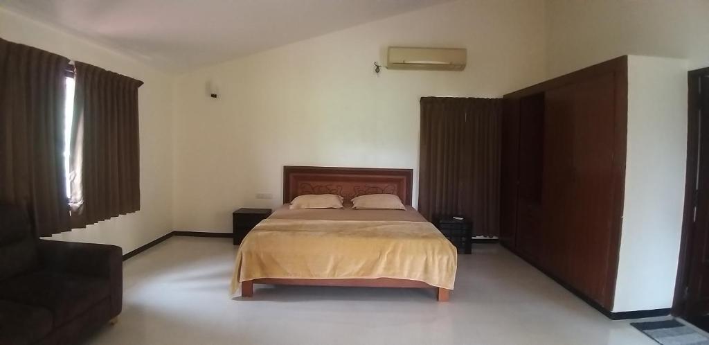 a bedroom with a bed with two pillows on it at Shiraz villa in Chennai