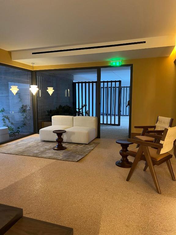 a living room with a couch and a table at Alinea Market Agora Square in Limassol