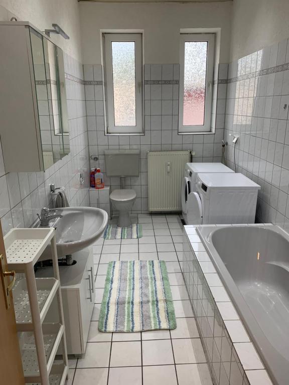 a bathroom with a tub and a sink and a toilet at 6 Personen / WIFI / Castrop-Rauxel in Castrop-Rauxel