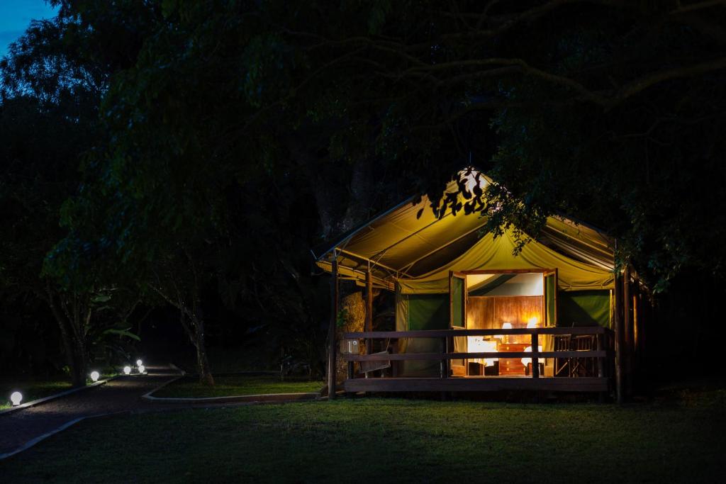 a tent with a window in the night at Falaza Game Park and Spa in Hluhluwe