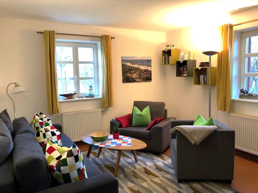 a living room with two couches and a table at Feriendorf Rugana - Komfort Appartement mit 1 Schlafzimmer und Terrasse B37 in Dranske