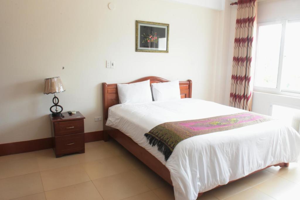 Postel nebo postele na pokoji v ubytování Coecco Xieng Khouang Hotel