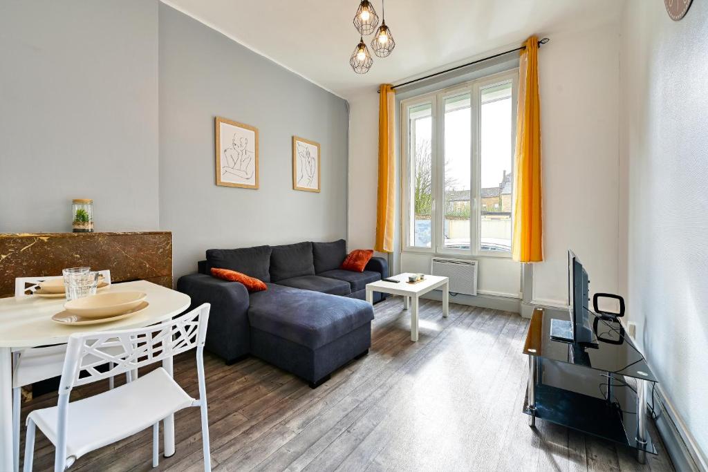 sala de estar con sofá y mesa en L'Instant Présent - Appt pour 4 en Charleville-Mézières