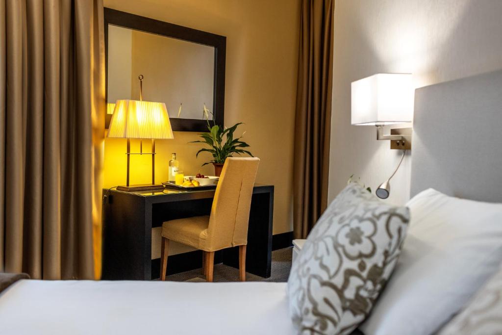 Postel nebo postele na pokoji v ubytování Hotel Monasterio Benedictino