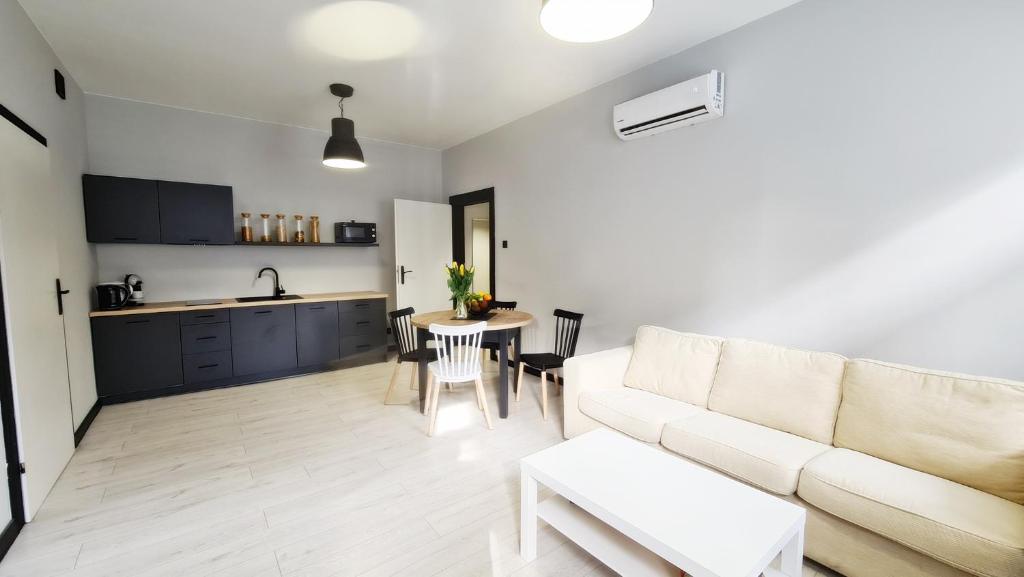 a living room with a couch and a table at Lokum z ogrodem in Płock