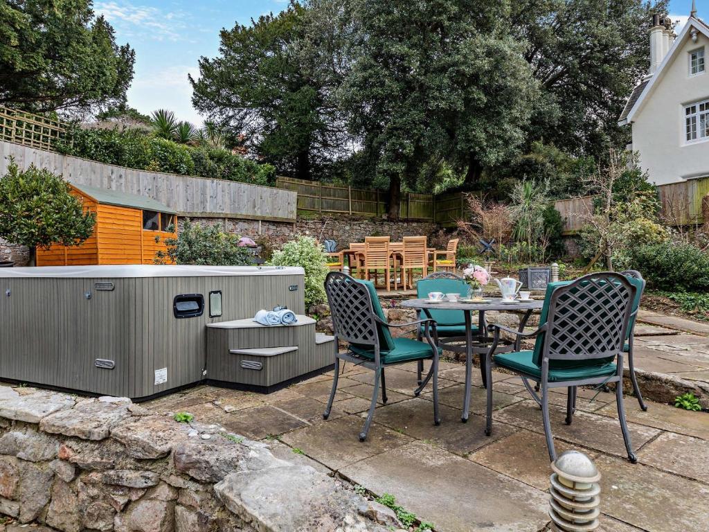 a patio with a table and chairs in a yard at 4 Bed in Torquay 94002 in Torquay