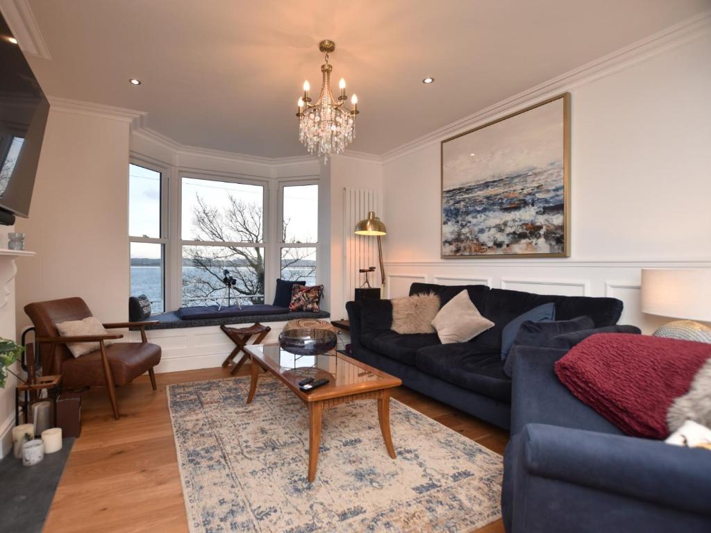 a living room with a couch and a table at 4 Bed in Aberdovey 94232 in Aberdyfi