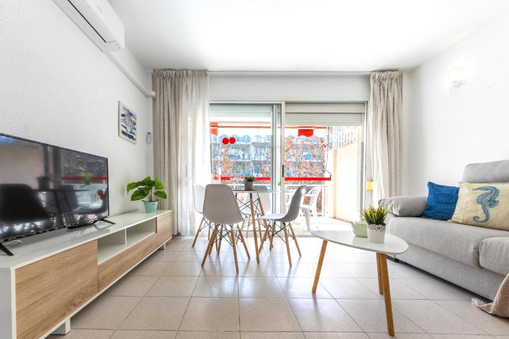 a living room with a couch and a tv at Apartamentos Varadero Arysal in Salou