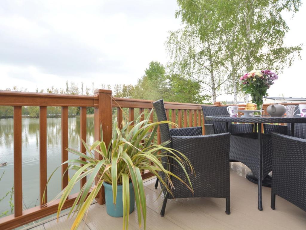 a patio with a table and chairs and a plant at 2 Bed in Tattershall Lakes 50360 in Tattershall