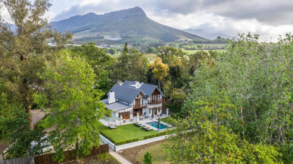 an aerial view of a house with a mountain in the background at Simonzicht Guest House in Stellenbosch