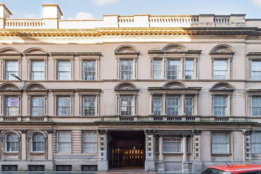 a large building with many windows on a street at Casa de Canada Court in Glasgow