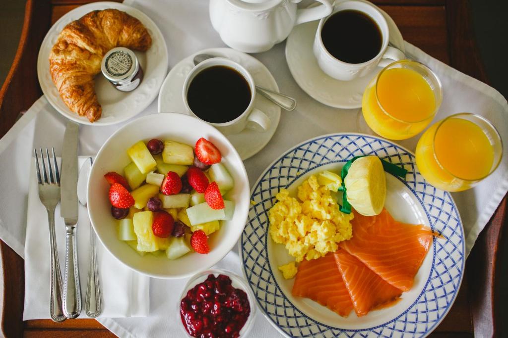 a table with plates of breakfast food and cups of coffee at Bushmills Inn Hotel & Restaurant in Bushmills