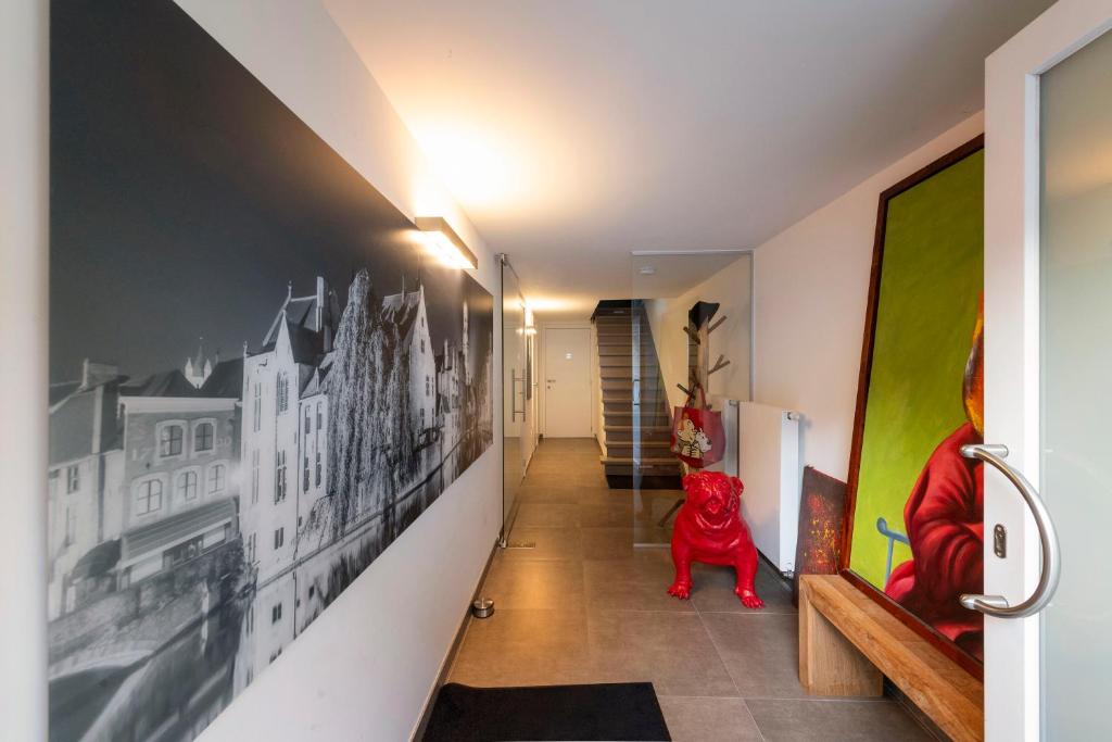 a hallway with black and white pictures on the walls at Chez RG in Bruges