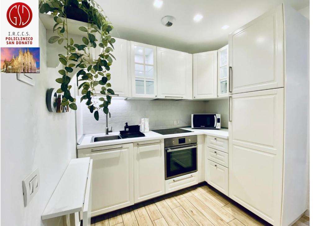 a white kitchen with white cabinets and a sink at NEW - Nuovo appartamento in centro in San Donato Milanese