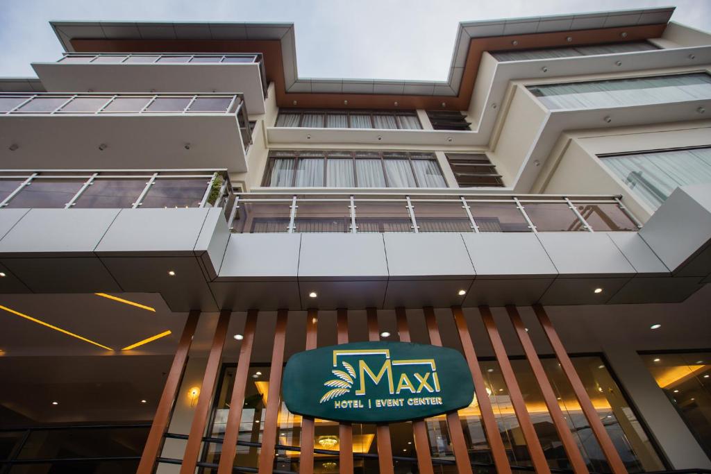 a view of the front of a building with a max sign at Maxi Hotel and Event Center in Tagbilaran City