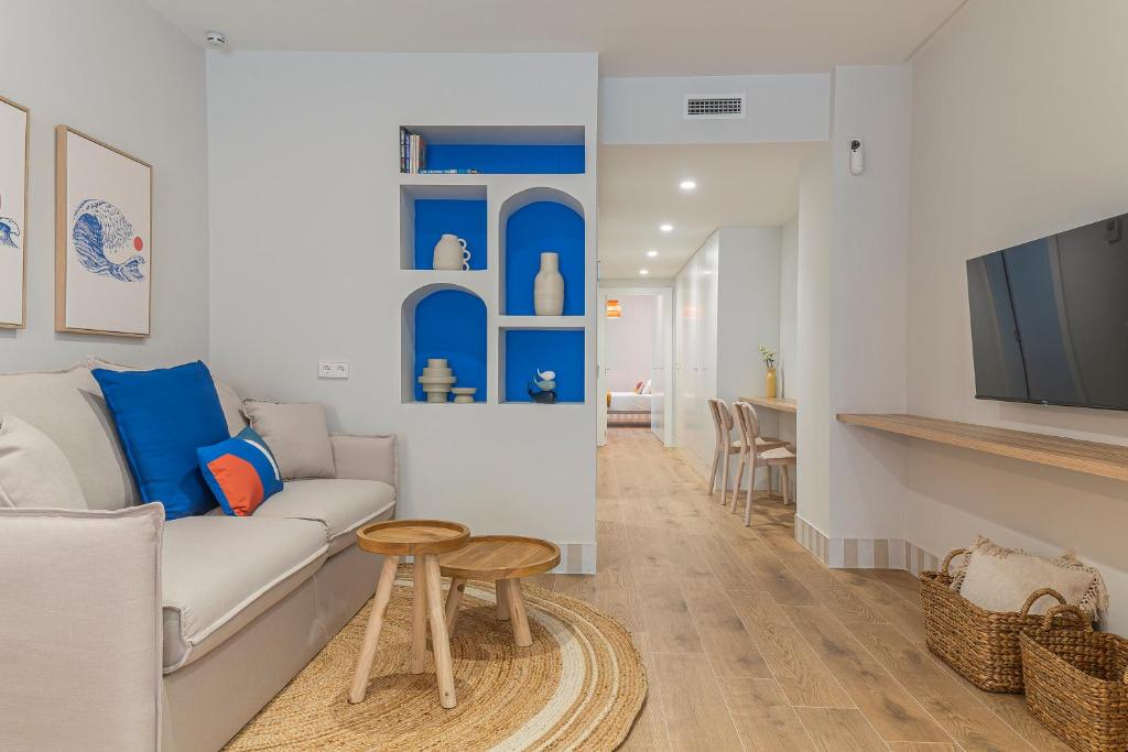 a living room with a couch and a table at Malvarrosa Beach Stay! in Valencia