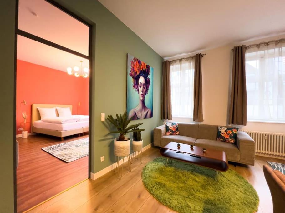 a living room with a couch and a table at Exklusives Leipzig City Apartment Flowers in Leipzig