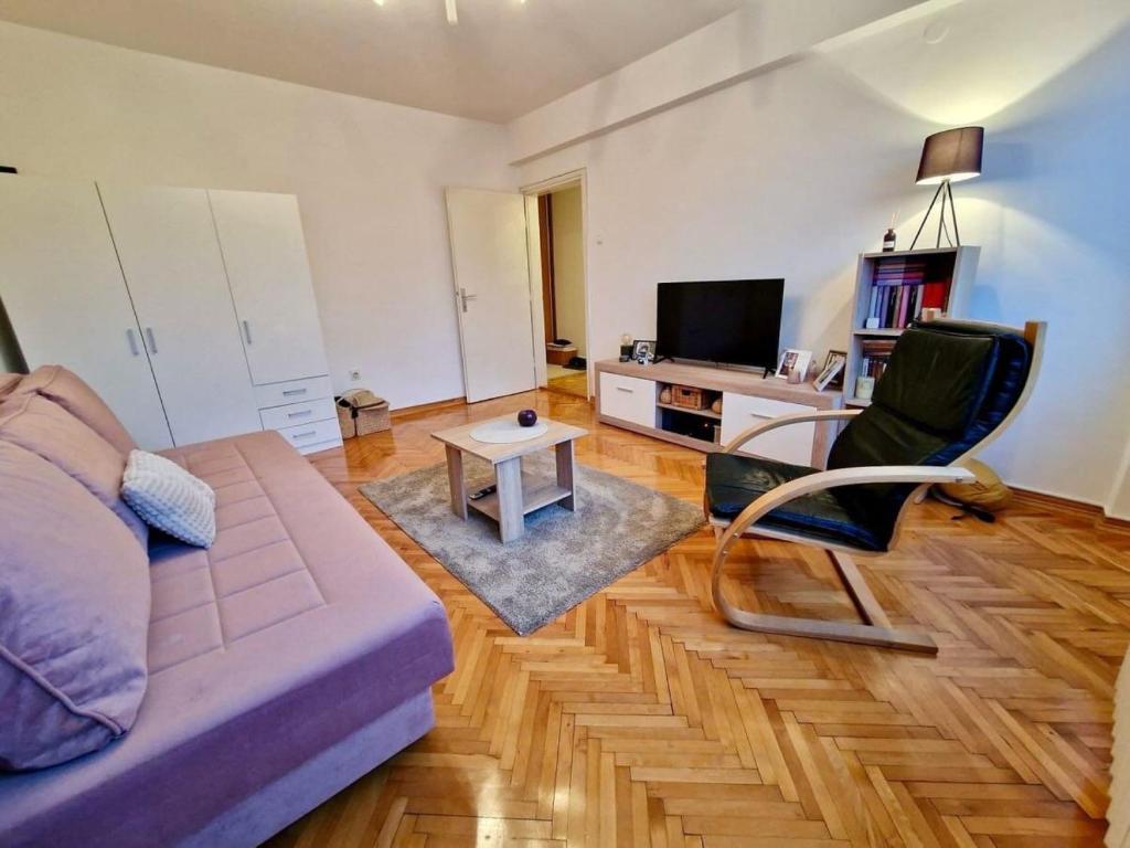 uma sala de estar com um sofá e uma mesa em Dino apartment em Sarajevo