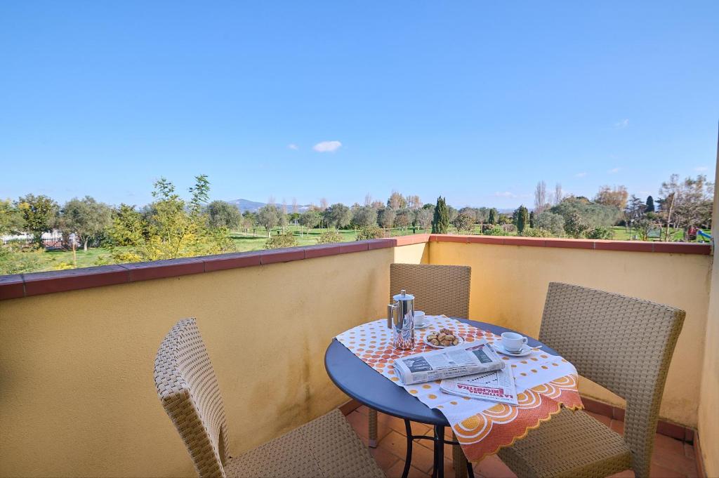 a table and chairs on a balcony with a view at Poggio all'Agnello Sport & Family Holidays in Populonia