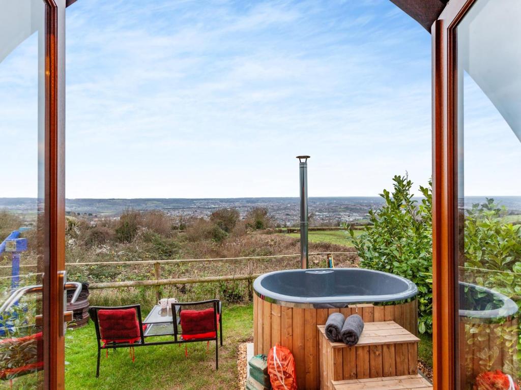 a hot tub on a patio with a view at 1 Bed in Bristol 94007 in Chew Magna