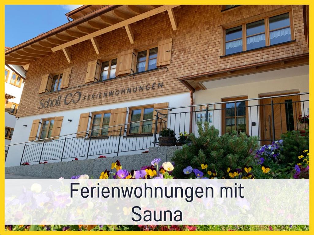 a building with flowers in front of it at Ferienwohnungen Scholl - private Sauna oder Infrarotkabine in Bad Hindelang
