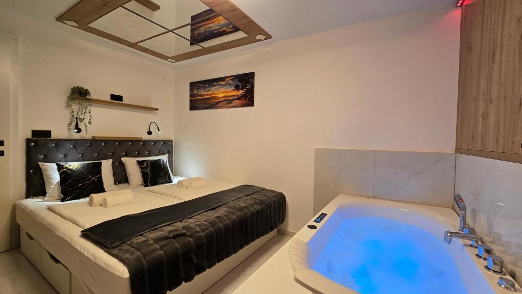 a bedroom with a bed and a bath tub at Adriatic SPA Apartment in Selce