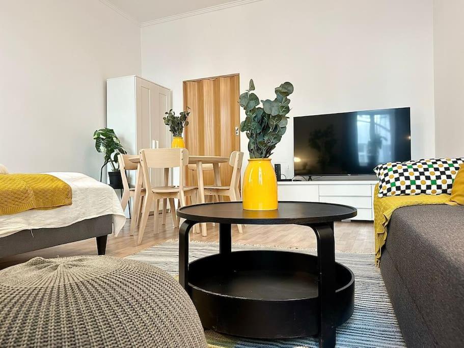a living room with a table with a yellow vase on it at Chic Vienna Apartment in Vienna