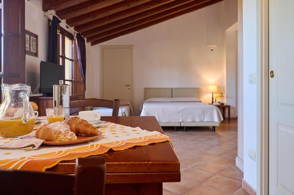 a room with a table with a plate of food on it at Poggio all'Agnello Sport & Family Holidays in Populonia