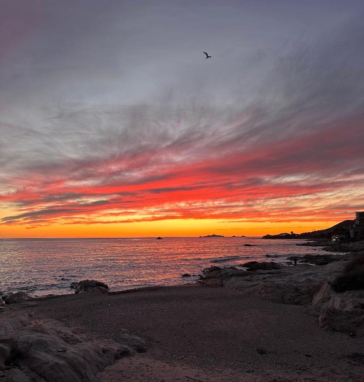 a sunset over the ocean with a sandy beach at Casa Mare, CABANON SUR LA PLAGE à Ajaccio vue sanguinaires in Ajaccio