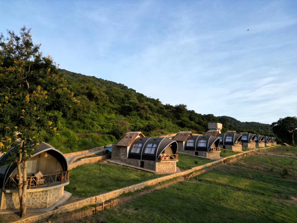 a row of domes in a field with a mountain at Africa Safari Rift Valley 