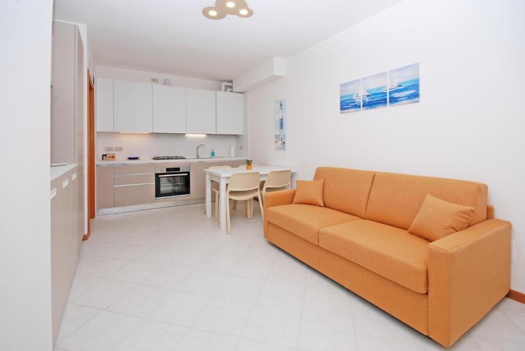 a living room with a couch and a table at Corallo Cavallino in Cavallino-Treporti