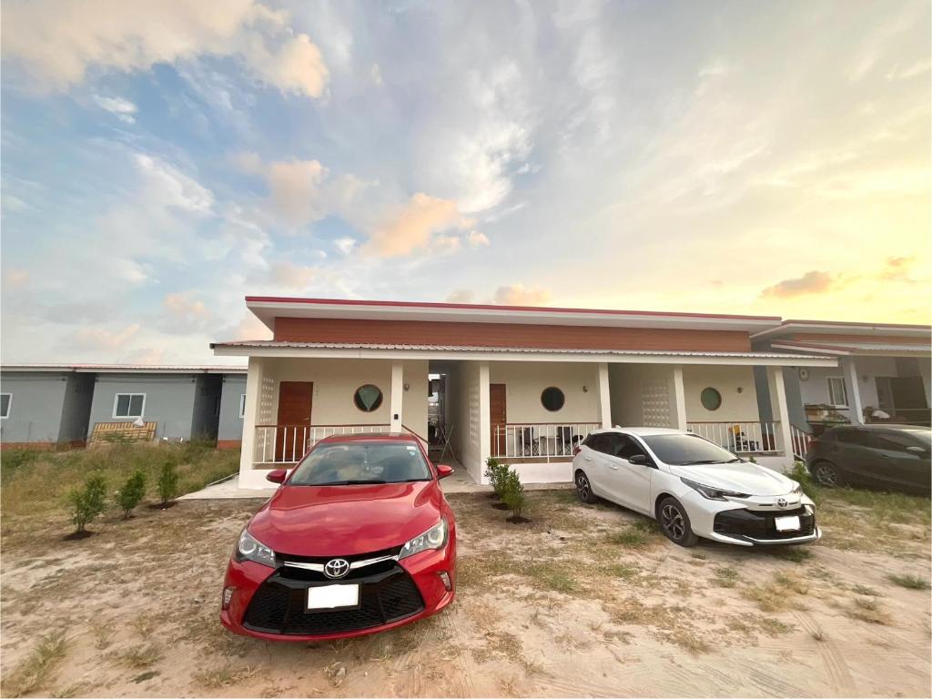 two cars parked in front of a house at Yourbed & House in Bangrak Beach