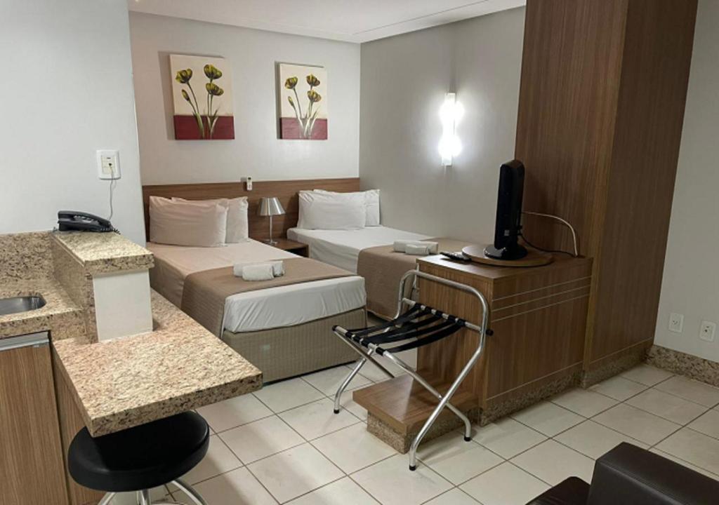 Postel nebo postele na pokoji v ubytování Sun Square Suítes Hotel By Lual