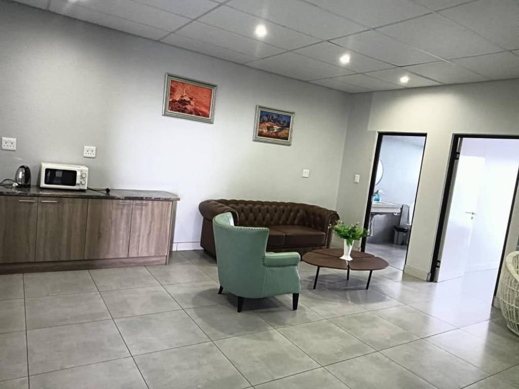 a living room with a couch and a chair at City Centre Hotel in Walvis Bay