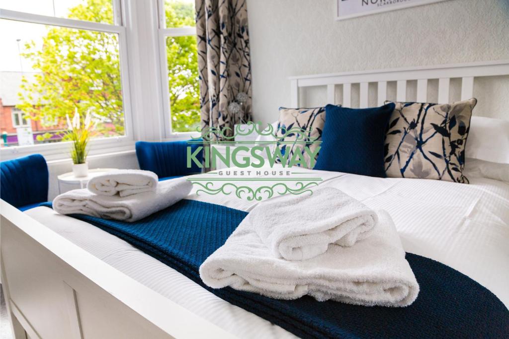 um quarto com toalhas azuis e brancas numa cama em Kingsway Guesthouse - A selection of Single, Double and Family Rooms in a Central Location em Scarborough
