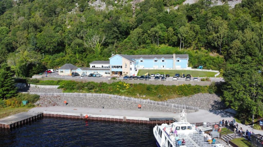 a cruise ship docked at a dock in the water at Loch Ness Clansman Hotel in Drumnadrochit