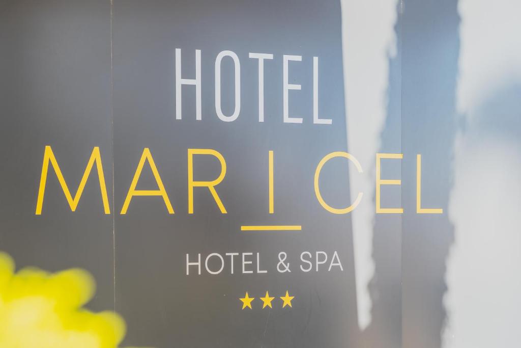 a sign that says hotel marcel on a window at Hôtel Mar I Cel &amp; Spa in Canet-en-Roussillon