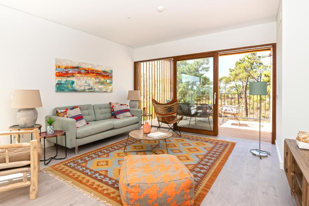 a living room with a couch and a table at Pestana Troia Eco-Resort & Residences in Troia