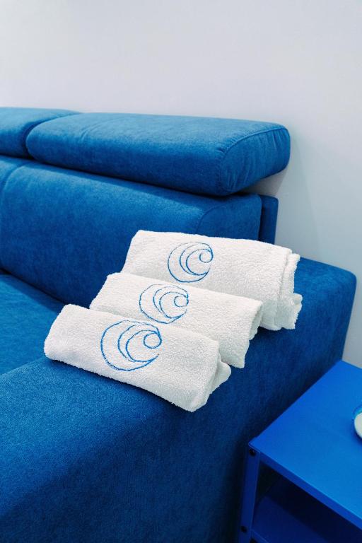 un paio di asciugamani su un divano blu di Casa Celeste a Monopoli
