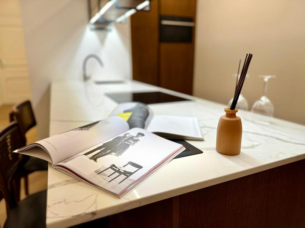 a desk with a book and a lamp on it at Maison Frank in Budapest