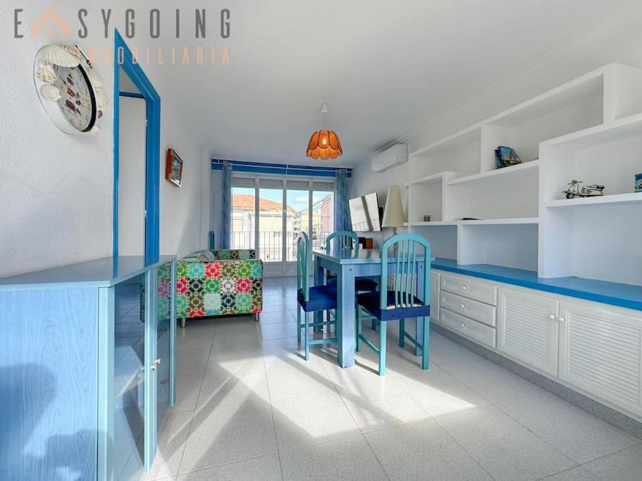a kitchen with a blue table and chairs in it at ¡El Pescador - junto al mar! in Santa Pola