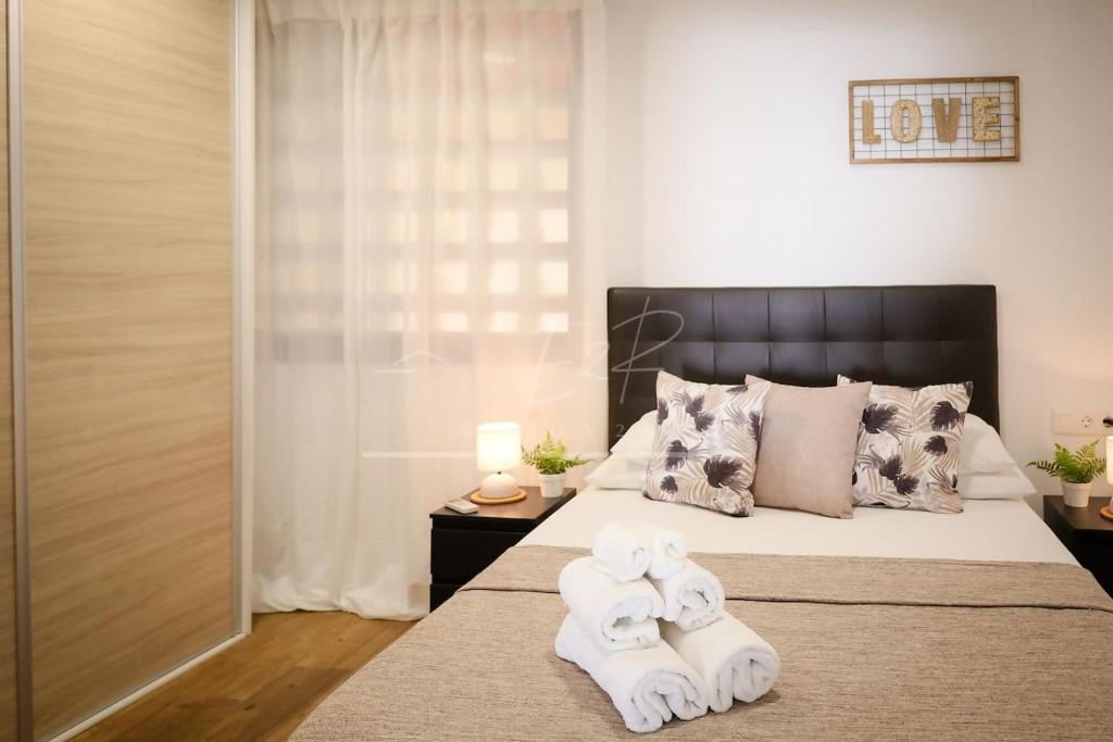 a bedroom with a bed with two towels on it at BelMonStays Lubina del Sol, Riviera, Mijas Costa in Mijas Costa
