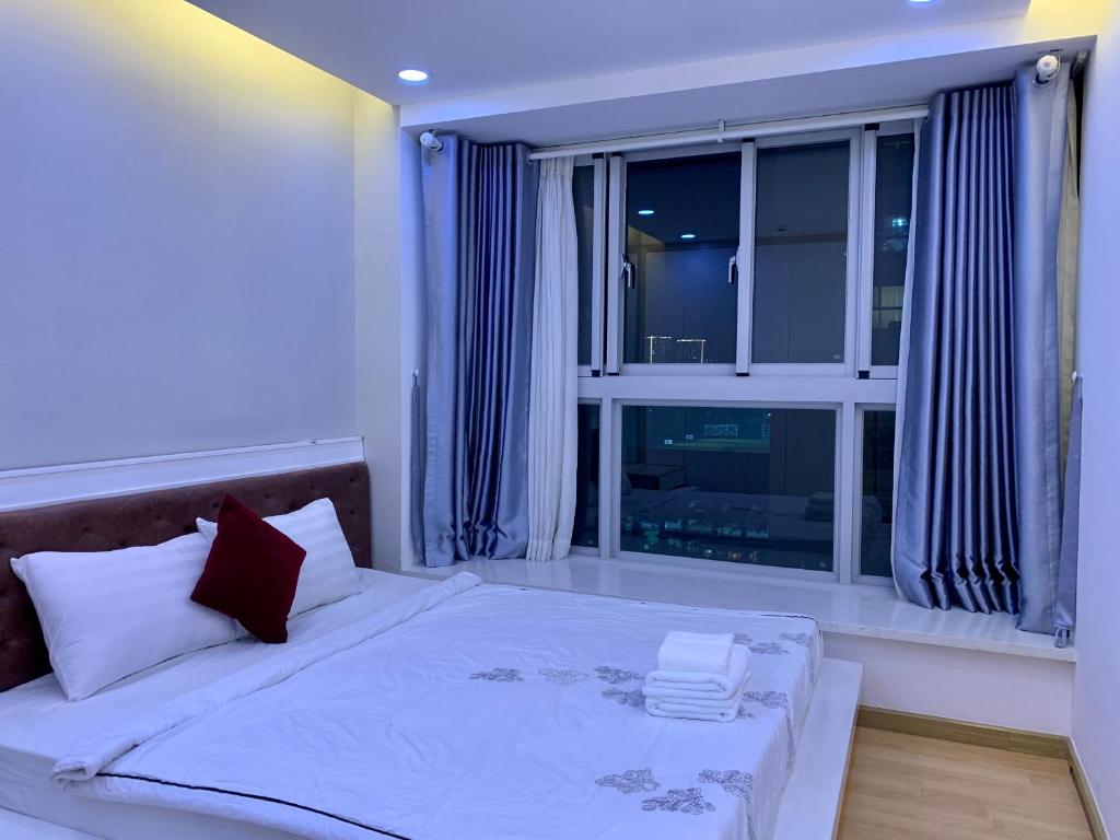 a bedroom with a large window and a bed with pillows at 2 Bedrooms Scenic valley Big Free: Breakfast, Massage, More Discount Supermarket in Ho Chi Minh City