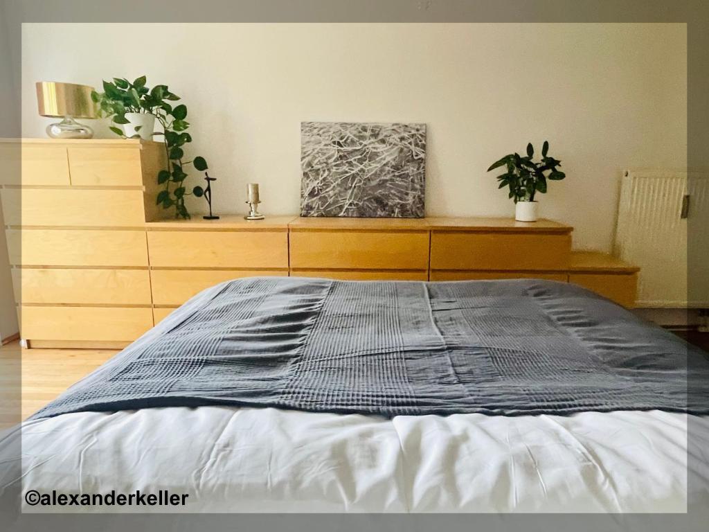 Schönes und ruhiges Privatzimmer mit französischem Balkon في ميونخ: غرفة نوم مع سرير وخزانة