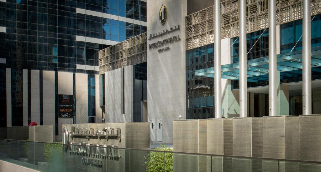 a building with a bunch of chairs in front of it at InterContinental Dubai Marina by IHG in Dubai