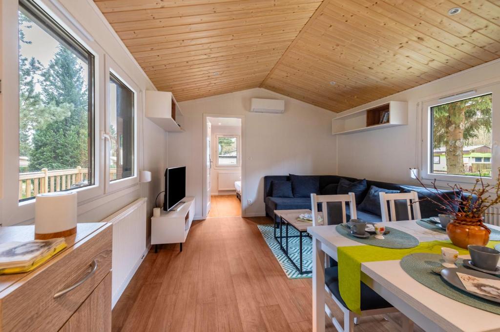 a tiny house with a kitchen and a living room at Haus Zander in Lohmen